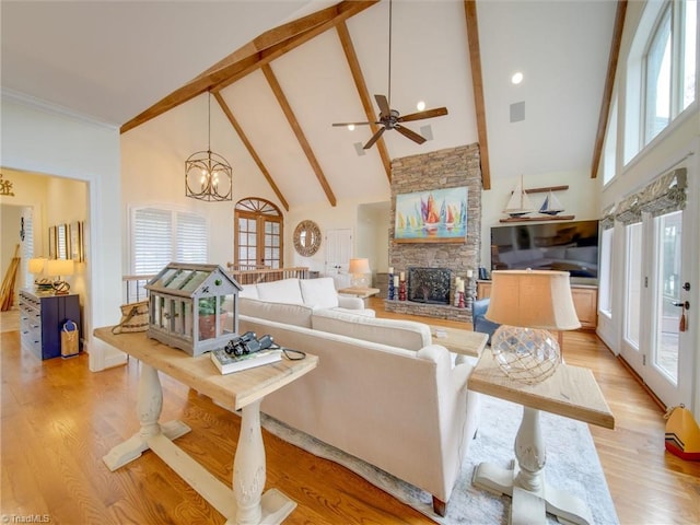 living room featuring plenty of natural light, high vaulted ceiling, and light hardwood / wood-style flooring