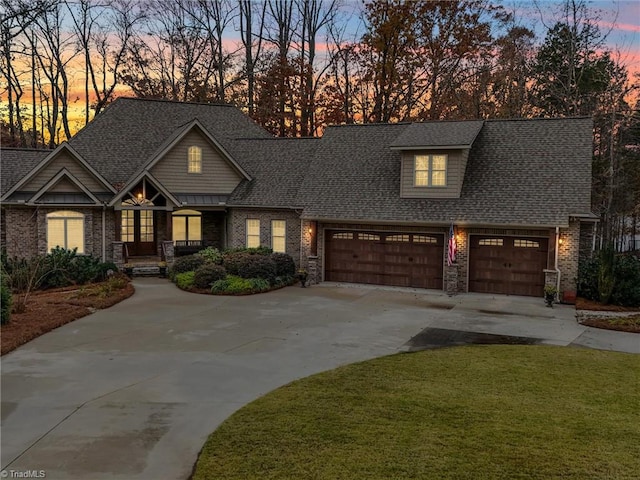 view of front of home featuring a lawn and a garage