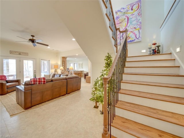 stairway with french doors and ceiling fan