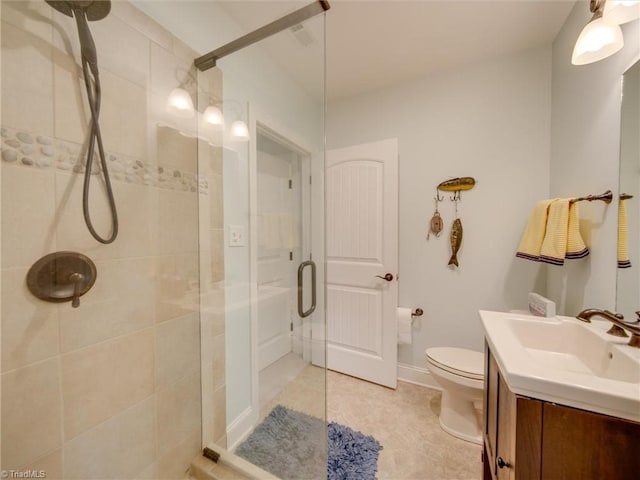 bathroom featuring tile patterned floors, vanity, an enclosed shower, and toilet