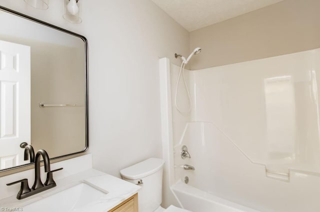 bathroom featuring bathing tub / shower combination, a textured ceiling, toilet, and vanity