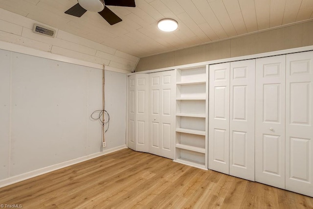 unfurnished bedroom featuring wood ceiling, light wood finished floors, visible vents, and a ceiling fan