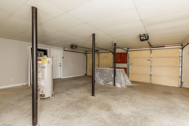 garage featuring baseboards, gas water heater, and a garage door opener