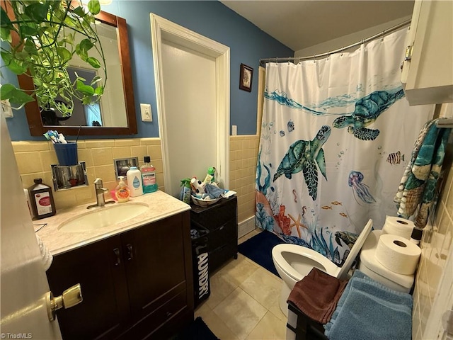2800 Loch Dr, Winston-Salem, NC 27106 - full bathroom with tile walls, tile patterned floors, toilet, vanity, and wainscoting