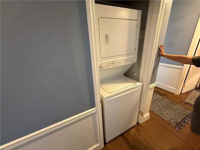 2800 Loch Dr, Winston-Salem, NC 27106 - laundry area with stacked washer and clothes dryer, wood finished floors, and baseboards