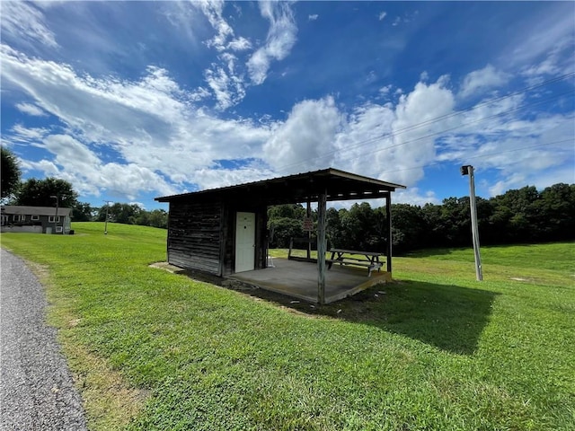 surrounding community featuring a lawn and an outbuilding