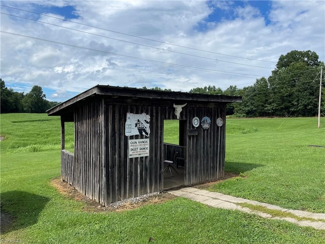 view of outbuilding featuring a yard