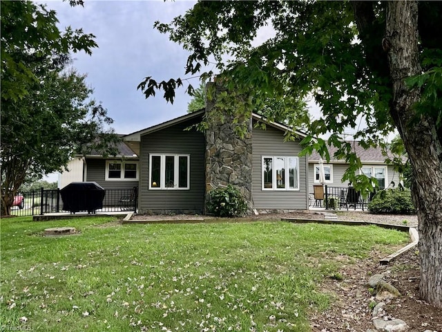 back of house featuring a patio and a lawn