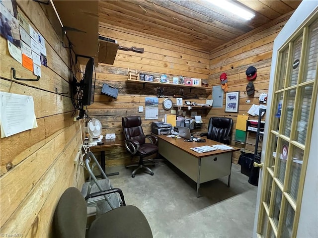 home office with concrete floors, wood ceiling, and wooden walls