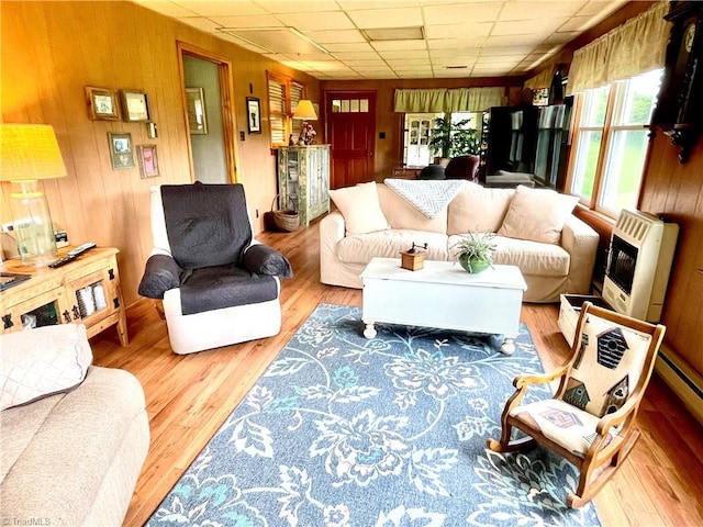 living room with hardwood / wood-style flooring and wooden walls