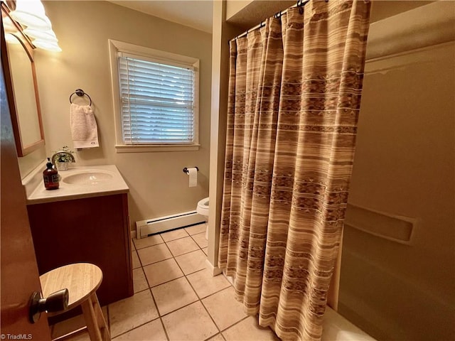 bathroom featuring tile patterned flooring, toilet, vanity, and a baseboard radiator