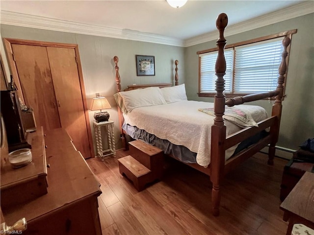 bedroom with crown molding and light hardwood / wood-style flooring