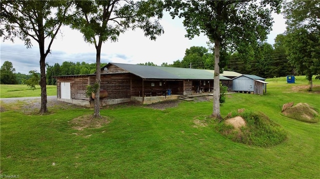 exterior space with a storage unit and a yard