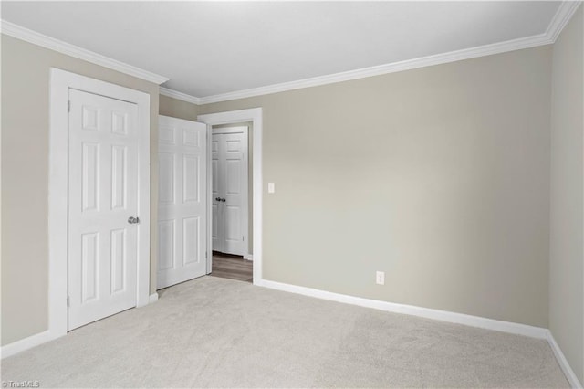 unfurnished bedroom with light colored carpet, ornamental molding, and a closet