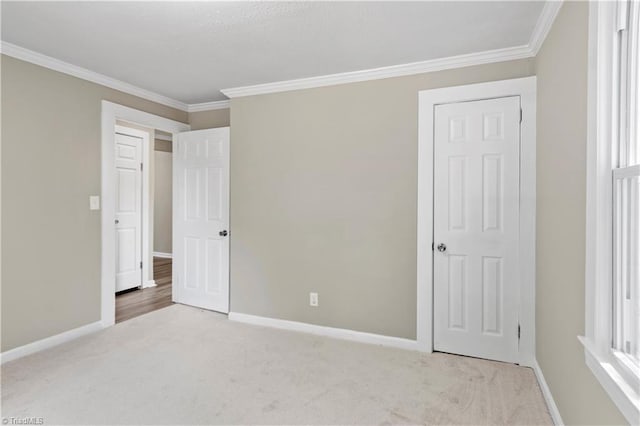 unfurnished bedroom featuring light carpet and ornamental molding