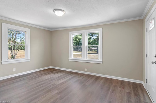 unfurnished room with ornamental molding, a healthy amount of sunlight, and wood-type flooring