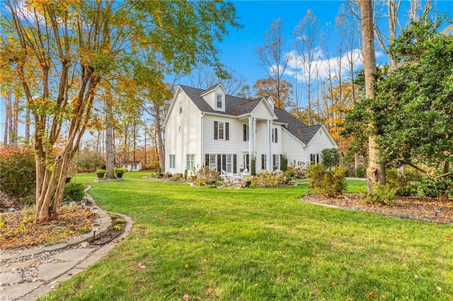 view of side of home with a yard