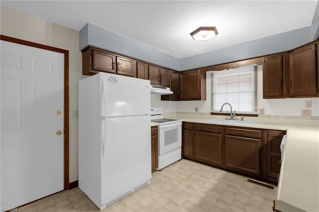 kitchen featuring a textured ceiling, dark brown cabinets, white appliances, and sink