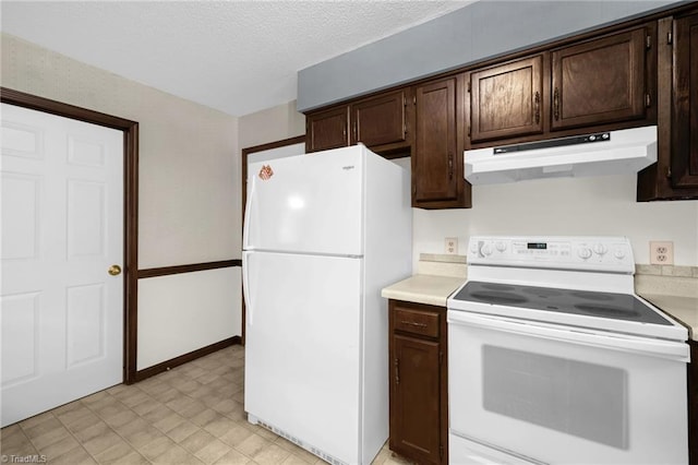 kitchen featuring a textured ceiling, dark brown cabinetry, and white appliances