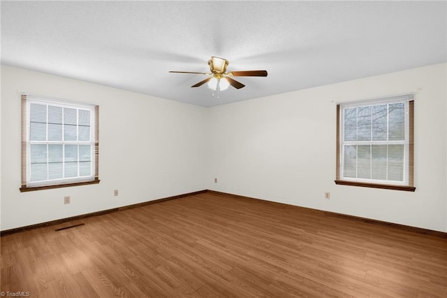 spare room with ceiling fan and wood-type flooring