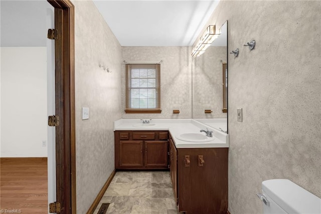 bathroom featuring vanity and toilet