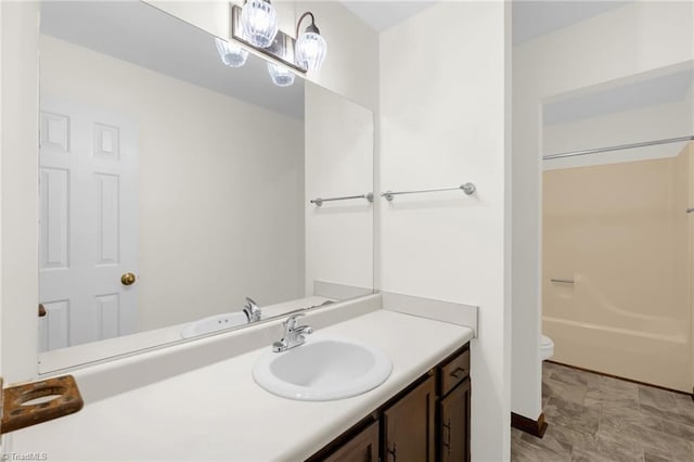 bathroom featuring vanity and toilet