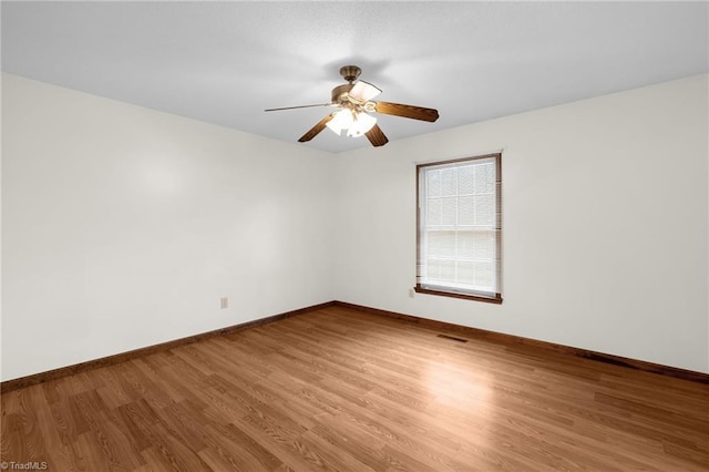 spare room featuring wood-type flooring