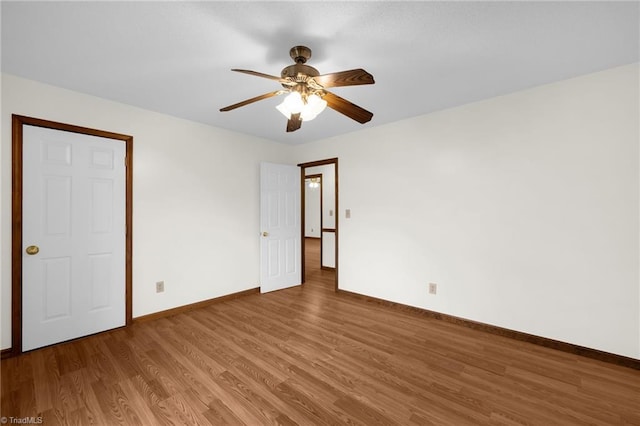 empty room featuring hardwood / wood-style flooring and ceiling fan