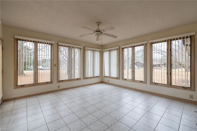 unfurnished sunroom featuring ceiling fan