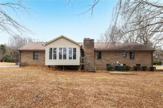 rear view of property featuring central AC unit