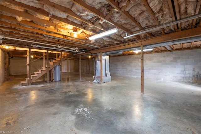 basement featuring heating unit and water heater