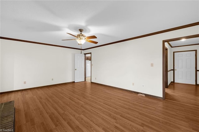 empty room with dark hardwood / wood-style floors, ceiling fan, and crown molding