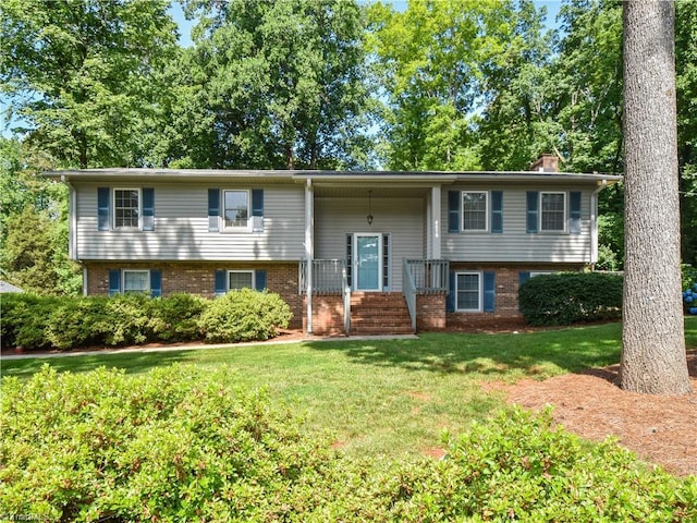4610 Woodsman Way, Winston-Salem, NC 27103 - bi-level home with brick siding, a front yard, and a chimney