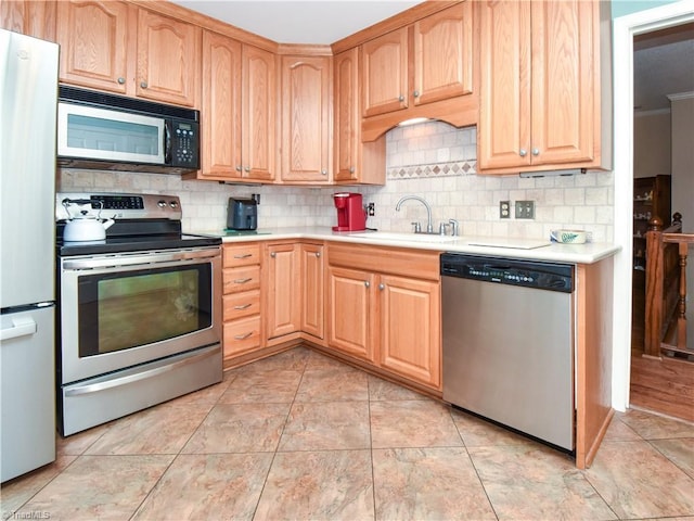 4610 Woodsman Way, Winston-Salem, NC 27103 - kitchen featuring appliances with stainless steel finishes, light countertops, tasteful backsplash, light brown cabinets, and ornamental molding