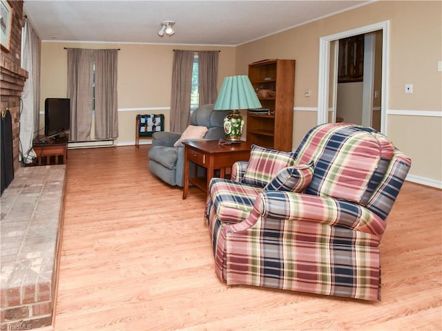 4610 Woodsman Way, Winston-Salem, NC 27103 - living room featuring wood finished floors, a fireplace, crown molding, and a baseboard radiator