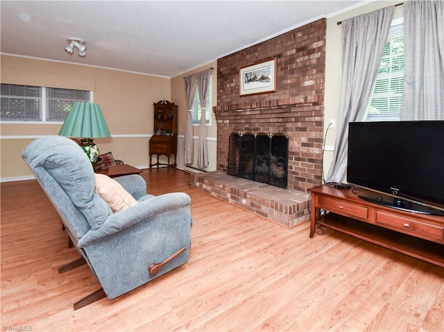 4610 Woodsman Way, Winston-Salem, NC 27103 - living room featuring wood finished floors, plenty of natural light, ornamental molding, and a fireplace