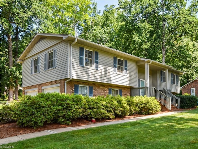 4610 Woodsman Way, Winston-Salem, NC 27103 - view of front of house with an attached garage, a front yard, and brick siding