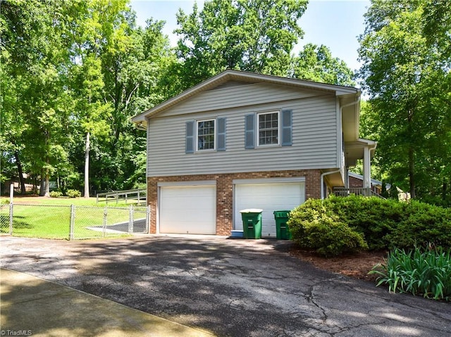 4610 Woodsman Way, Winston-Salem, NC 27103 - view of side of property featuring brick siding, asphalt driveway, and an attached garage