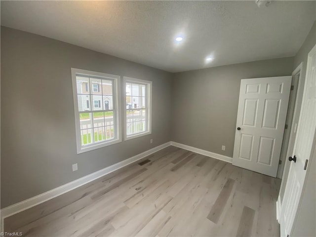 7 Crutchfield Ave, Lexington, NC 28445 - spare room with light wood-style floors, baseboards, a textured ceiling, and recessed lighting