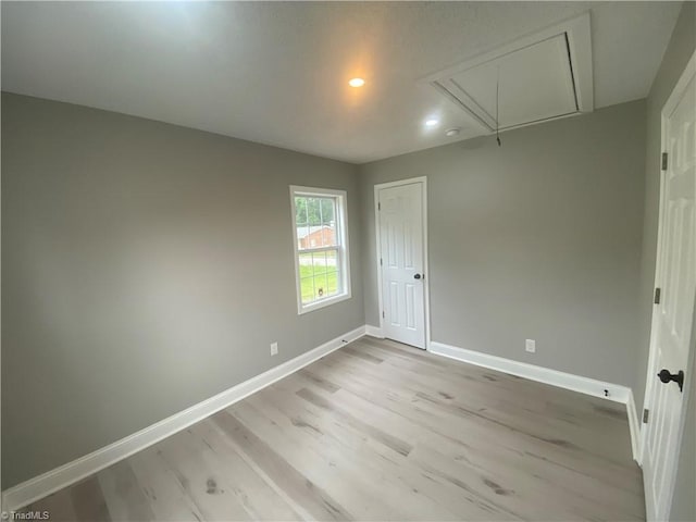 7 Crutchfield Ave, Lexington, NC 28445 - spare room featuring attic access, baseboards, light wood-type flooring, and recessed lighting