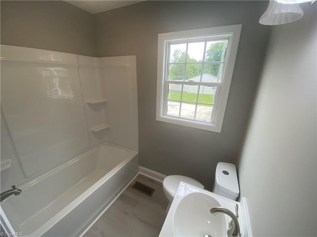 7 Crutchfield Ave, Lexington, NC 28445 - bathroom featuring toilet, baseboards, shower / tub combination, and a sink