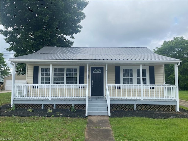 7 Crutchfield Ave, Lexington, NC 28445 - view of front of house with a porch, metal roof, and a detached garage