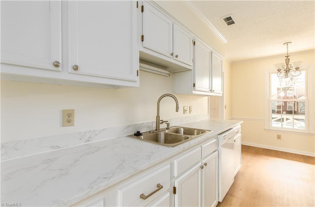 2744 Windy Xing, Winston-Salem, NC 27127 - kitchen with visible vents, light wood finished floors, dishwasher, white cabinetry, and a sink