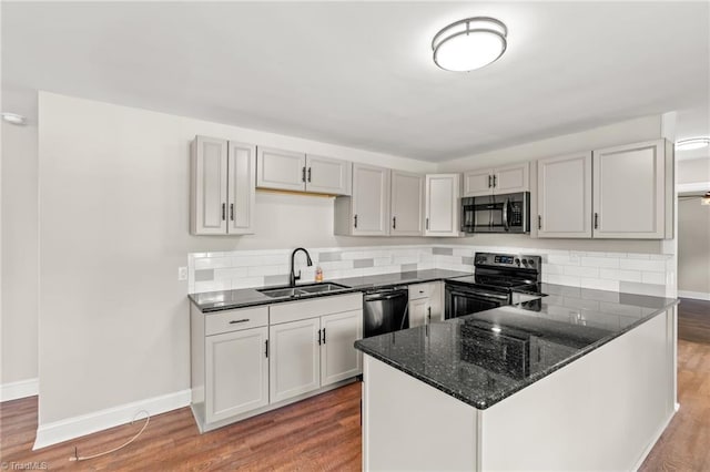 212 Lakeview Dr E, Thomasville, NC 27360 - kitchen featuring electric stove, stainless steel microwave, dark stone countertops, and wood finished floors