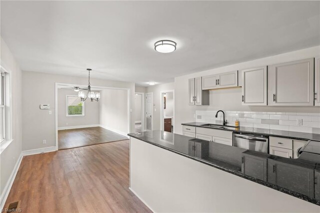 212 Lakeview Dr E, Thomasville, NC 27360 - kitchen featuring stainless steel dishwasher, wood finished floors, dark stone countertops, a chandelier, and pendant lighting