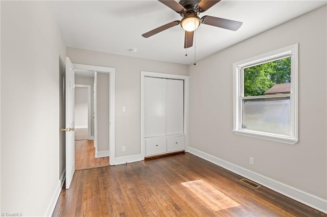212 Lakeview Dr E, Thomasville, NC 27360 - unfurnished bedroom with wood finished floors, a closet, and a ceiling fan