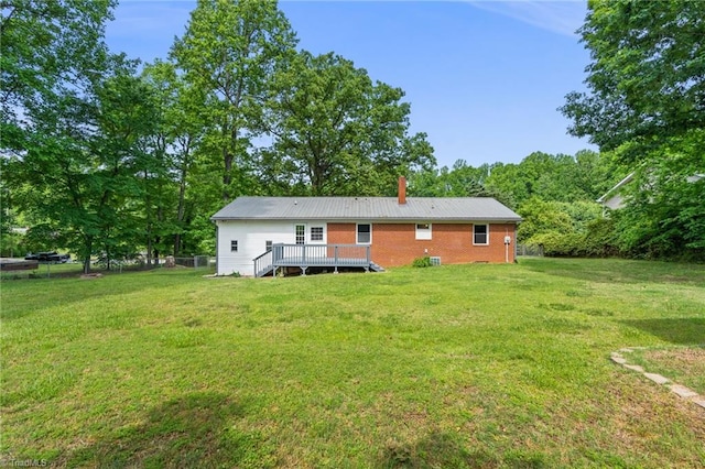 212 Lakeview Dr E, Thomasville, NC 27360 - rear view of house with a wooden deck, a yard, a chimney, and brick siding