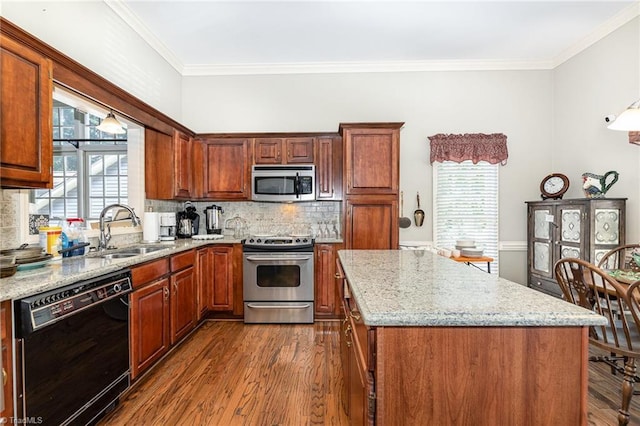 2000 Williamsburg Manor Ct, Winston-Salem, NC 27103 - kitchen with stainless steel appliances, dark wood finished floors, a kitchen island, light stone countertops, and crown molding