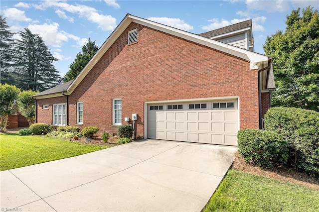 2000 Williamsburg Manor Ct, Winston-Salem, NC 27103 - view of property exterior with brick siding, concrete driveway, a yard, and a garage