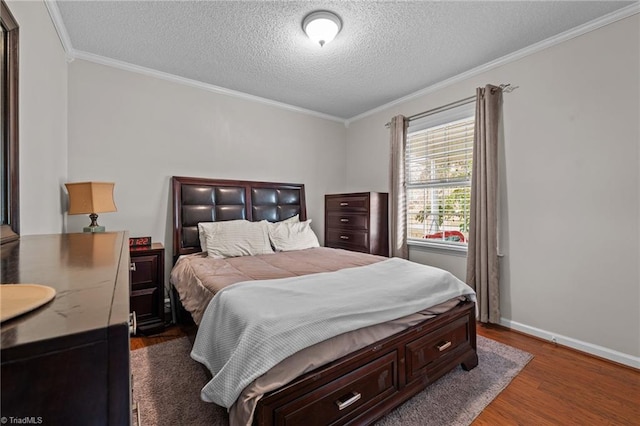 bedroom featuring crown molding, dark wood-type flooring, and a textured ceiling